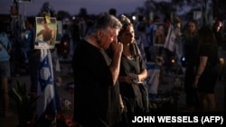 Relatives and other mourners of Israeli victims attend a ceremony at the Nova memorial near Kibbutz Reim in southern Israel on the first anniversary of the October 7, 2023, attack by Hamas.