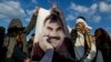 Supporters in Diyarbakir, Turkey, hold a banner of Kurdish leader Abdullah Ocalan as they celebrate his peace call on February 28.