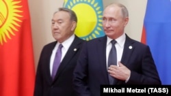 Russian President Vladimir Putin (right) could be looking for inspiration in the way his old Kazakh counterpart, Nursultan Nazarbaev, has stepped down but is still keeping his irons in the fire.