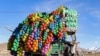 <p>An Afghan vendor carries plastic containers on a three-wheeler rickshaw in Maidan Wardak Province. 