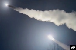 This image was made from a video posted by a Telegram channel affiliated with the Ukrainian military on November 19. The channel says it shows U.S.-supplied ATACMS missiles being fired from an undisclosed location in Ukraine.