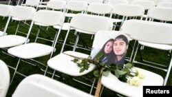 A picture of victims of the MH17 crash rests on empty chairs during a protest outside the Russian Embassy in The Hague on March 8.