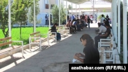 A crowd of people wait in line outside the offices of Turkmenistan's Migration Service in the eastern city of Turkmenabat in Lebap Province.