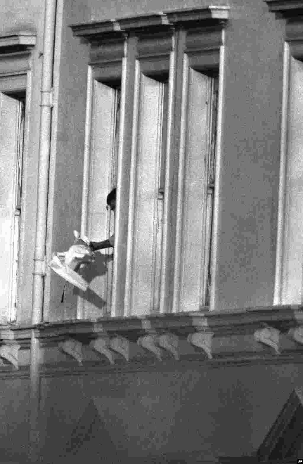 An unidentified person waves what appears to be a white flag from a window on the embassy&#39;s second floor on May 5. BBC correspondents on the spot reported that hostage takers tried to surrender after the building began to burn. According to one of the hostages, Syrian-born journalist Mustapha Karkouti, the gunmen were badly prepared and not well-informed about the capabilities of London&#39;s security forces.