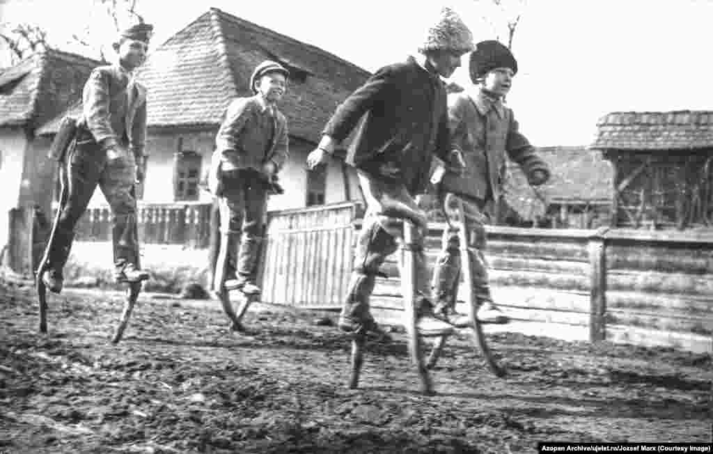 This image, of Romanian youngsters walking on stilts, is one of more than 5,000 photos published online in early November from salvaged archives of the Romanian photo journal Uj Elet. &nbsp;