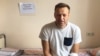 Jailed Russian opposition leader Aleksei Navalny sits on a hospital bed in Moscow on July 29. 