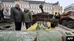 EU foreign policy chief Josep Borrell (right) and Ukrainian Foreign Minister Andriy Sybiha examine destroyed Russian military equipment at an open-air exhibition in Kyiv on November 9.