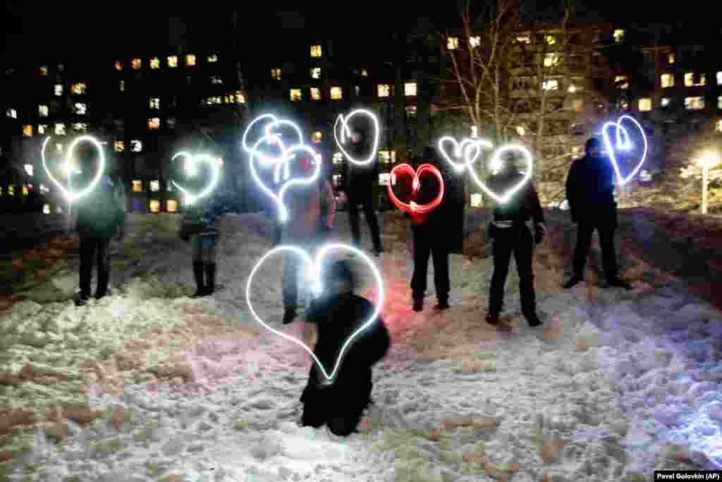 People draw hearts with their cell-phone flashlights in support of jailed opposition leader Aleksei Navalny and his wife, Yulia Navalnaya, in Moscow on the night of February 14. Navalny&#39;s team urged people to stand in their courtyards and shine their cell-phone flashlights under the slogan, &quot;Love is stronger than fear.&quot; After the jailing of Navalny and two weekends of nationwide demonstrations and marches, the new protest format looked to some like a retreat.