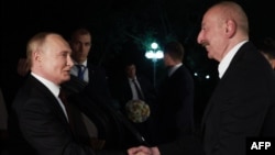 Vladimir Putin (left) is greeted by his Azerbaijani counterpart, Ilham Aliyev, upon the Russian president's arrival in Baku on August 18. 