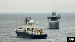 A British warship (right) tracks the Russian vessel Yantar during a previous encounter. (file photo)