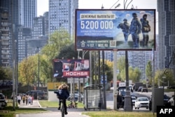 A billboard promoting contract army service reads "5.2 million rubles for the first year of the contract" (about $57,000) in western Moscow.