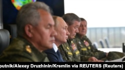 Russian President Vladimir Putin (center), Defense Minister Sergei Shoigu (left) and the chief of the General Staff of Russia's armed forces, Valery Gerasimov (right), observe the military exercises in September 2021.