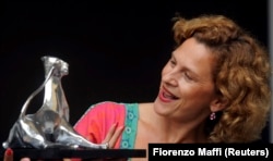 Jasna Djuricic holds her best-actress trophy as she poses during a photocall for the film White White World at the 63rd Locarno International Film Festival in August 2010.