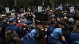 People attend the funeral of crew members of Azerbaijan Airlines flight J2-8243 that crashed near the Kazakh city of Aqtau, in Baku on December 29. 