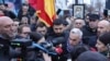 Calin Georgescu and dozens of his supporters gather outside a closed polling station in Bucharest on December 8.