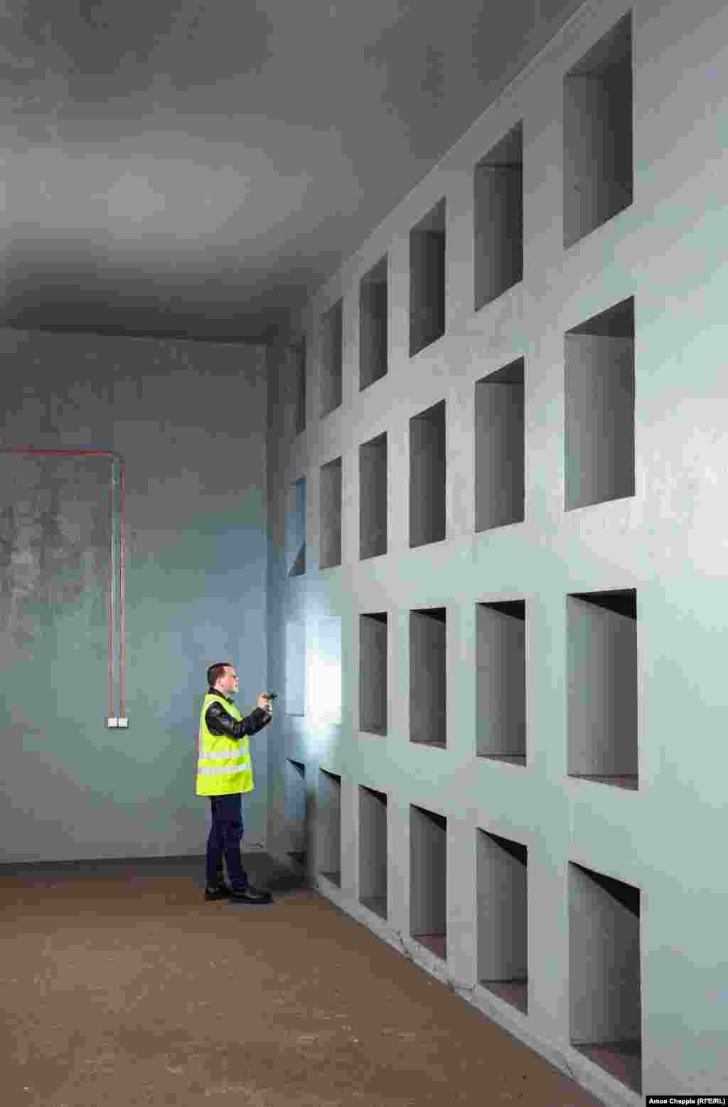 A subway worker inspects a wall of air filter intakes in the OSM. The network of shelters is designed to accommodate up to 320,000 people inside several specially equipped subway stations and the tunnels between them. &nbsp;