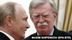 Russian President Vladimir Putin (left) meets with U.S. national-security adviser John Bolton in Moscow on October 23. 