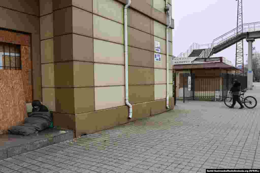 At Pokrovsk Railway Station the platforms are empty. This homeless man was trying to stay warm in a sleeping bag, and to get some sleep.