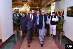 Pakistani Foreign Minister Shah Mahmood Qureshi (right) talks with U.S. special representative Thomas West as they arrive at a meeting in Islamabad in November to discuss Afghanistan.