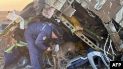 Emergency workers at the crash site of the Azerbaijan Airlines passenger jet near the western Kazakh city of Aqtau.