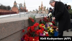 Politician Grigory Yavlinsky lays flowers at the site where Boris Nemtsov was killed on the fourth anniversary of his death on February 27.