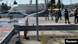 Rescuers work on a street where fragments of a downed Russian missile fell in Kyiv on May 29.