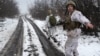 Soldiers walk along a snowy road in Ukraine's Luhansk region in December 2021.