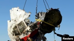 Local workers transport a piece of wreckage from Malaysia Airlines flight MH17 in the Donetsk region, where the plane was shot down in 2014, killing all 298 people on board.