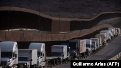 Trucks line up at the Mexican border before crossing into the United States near San Diego.