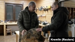 Vladimir Putin (right) and Sergei Shoigu visiting a workshop while vacationing together in Siberia in March 2021