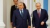 Hungarian Prime Minister Viktor Orban (left) and Russian President Vladimir Putin arrive at a press conference following their meeting in Moscow on July 5.