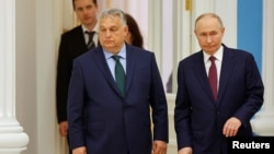 Hungarian Prime Minister Viktor Orban (left) and Russian President Vladimir Putin arrive at a press conference following their meeting in Moscow on July 5.