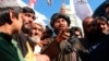 The dead body of a man accused of kidnapping hangs from a crane in the western Afghan city of Herat on September 25.