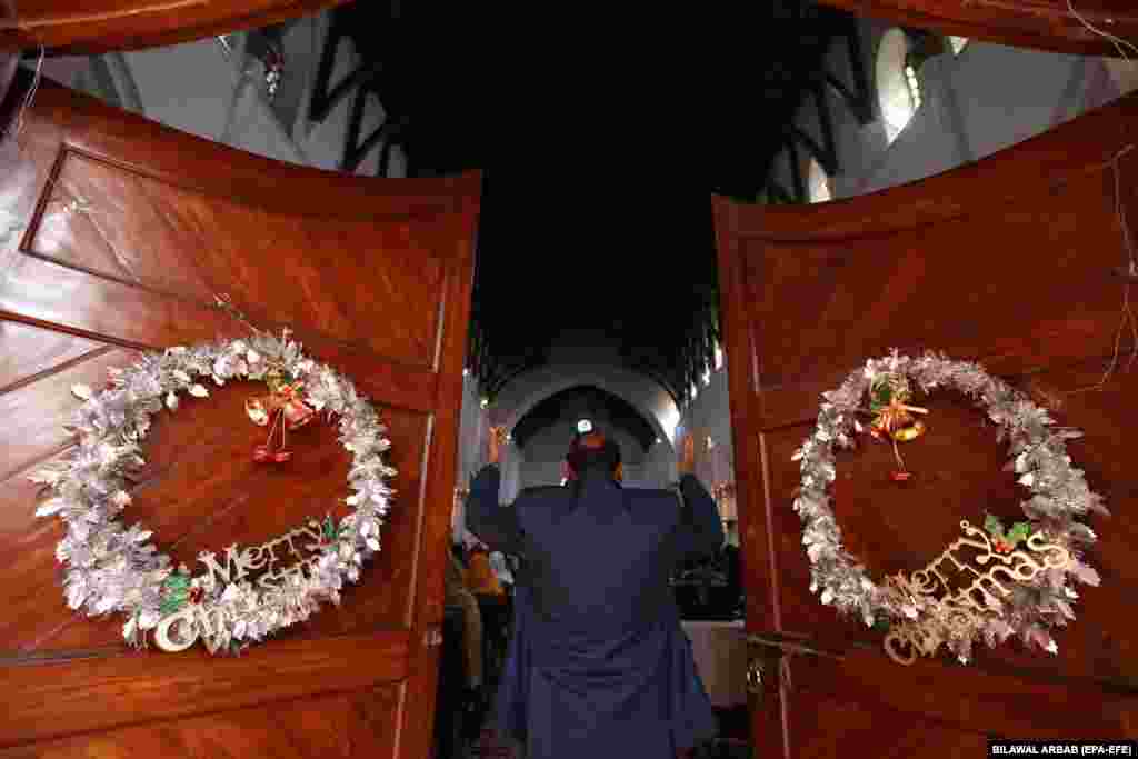 A member of the Christian minority community attends a Christmas mass at St. John&#39;s Cathedral Church in Peshawar, Pakistan.