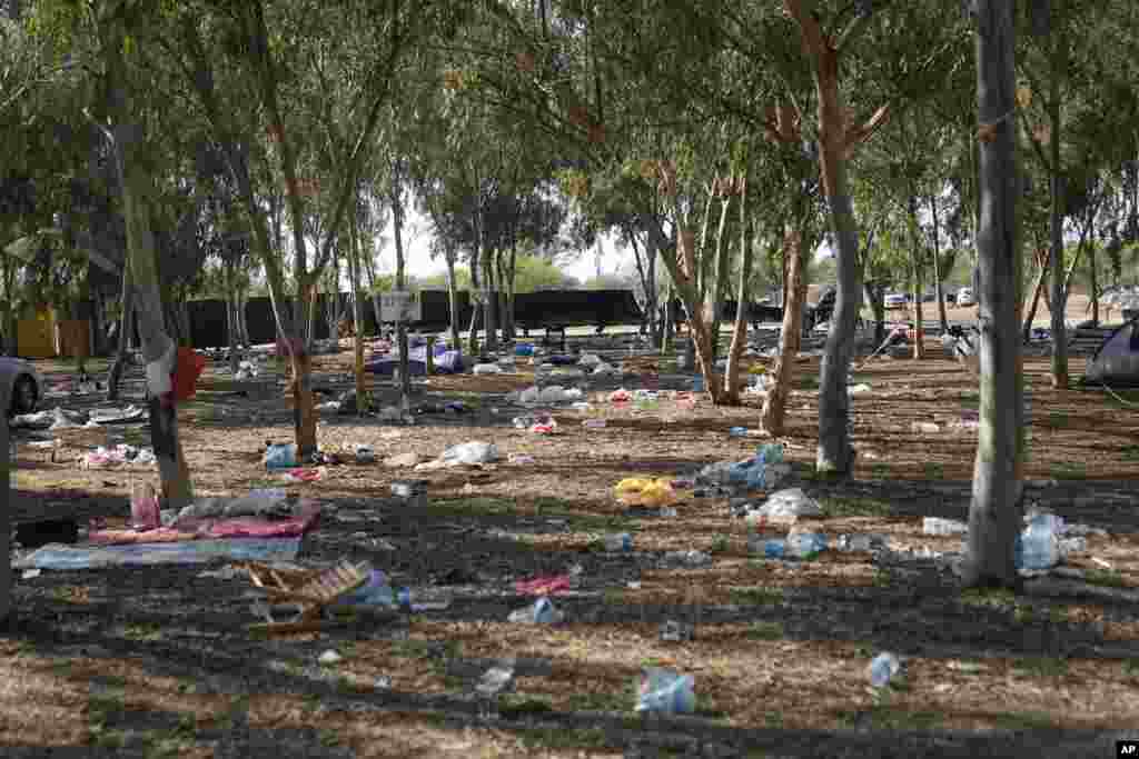 Debris strewn across the site of the music festival near the border with the Gaza Strip. At least 260 Israeli festivalgoers were killed by Hamas gunmen.