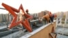 A communist red star is removed from a factory in Budapest in 1989.<br />
<br />
This October 26, 1989, photo was taken three days after Hungary proclaimed itself a democracy after 40 years under Soviet-backed communist rule. The image is one of several that plot the momentous events that transformed Hungary 35 years ago. &nbsp;<br />
<br />
&nbsp;