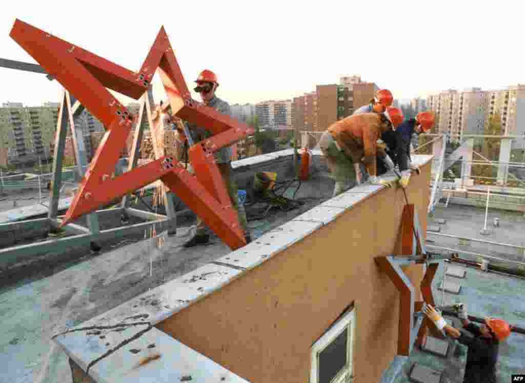 A communist red star is removed from a factory in Budapest in 1989. This October 26, 1989, photo was taken three days after Hungary proclaimed itself a democracy after 40 years under Soviet-backed communist rule. The image is one of several that plot the momentous events that transformed Hungary 35 years ago. &nbsp; &nbsp;