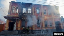 Firefighters work outside an office building destroyed by shelling in Donetsk, Ukraine, on December 5.