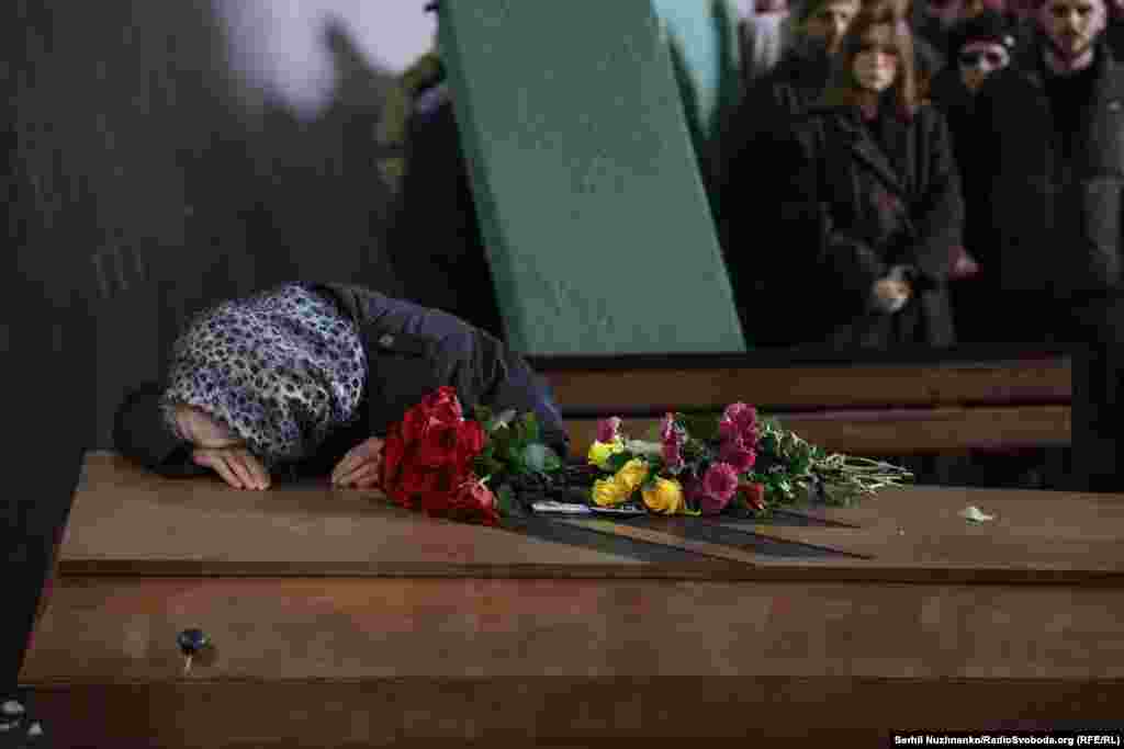 The mother of fallen soldier&nbsp;Danylo Lyashkevych weeps over his coffin during his funeral in Kyiv on November 8, 2024.&nbsp;