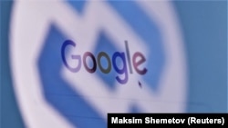 The logo of Russia's state communications regulator Roskomnadzor is reflected in a laptop screen showing the Google start page.