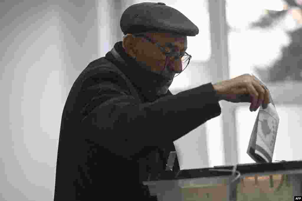 A man casts his ballot as part of the general elections at a polling station in Pristina on February 9.