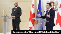 European Council President Charles Michel (left) last week called on Prime Minister Irakli Gharibashvili (right) and the country's political parties to engage in dialogue to defuse the "worsening crisis."