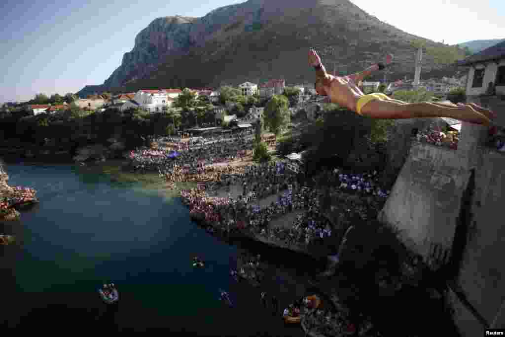 Diver Lorens Listo jumps from the center of Mostar&#39;s Stari Most, or Old Bridge. Diving competitions have been held here since the bridge was built 447 years ago, although the current formal competition dates back only to 1968.