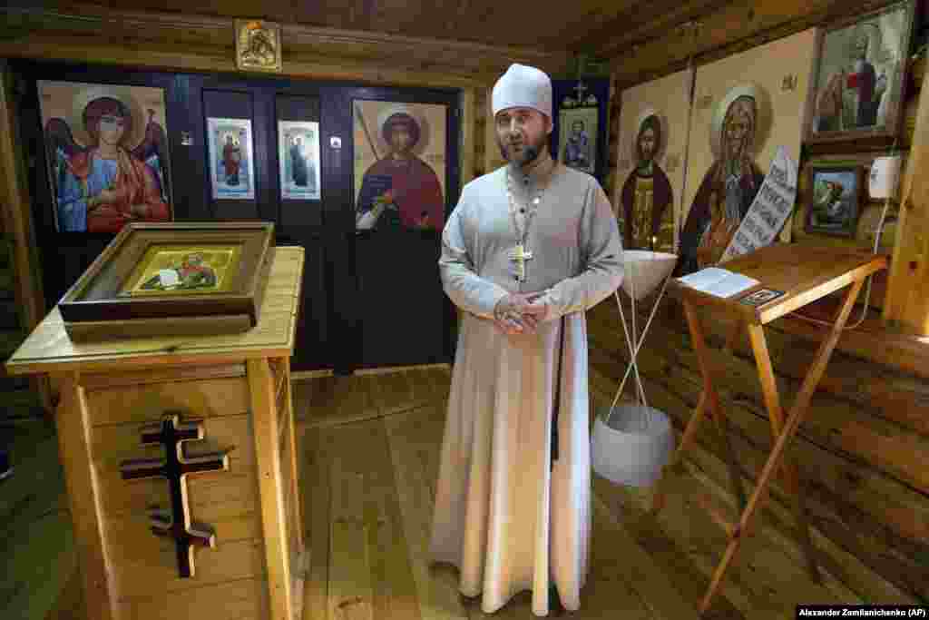 A Russian Orthodox priest stands inside a chapel at the Tartus naval facility in September 2019. A British intelligence report issued on December 13 linked the collapse of the Assad regime and subsequent shaky status of Russia&#39;s Syrian bases to the Kremlin&#39;s invasion of Ukraine.&nbsp;