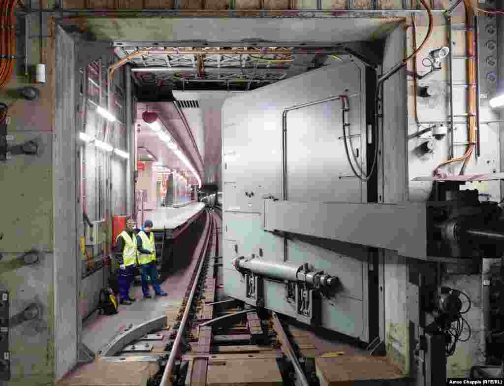 Engineers watch as the hermetically sealed blast door is closed over subway tracks.&nbsp; The OSM was built into Prague&rsquo;s subway network beginning in 1974 when the specter of nuclear war was haunting Europe. &nbsp;