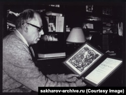 Sakharov studies his Nobel Prize diploma in his Moscow apartment in 1975.