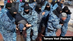 Kazakh police officers detain protesters during an opposition rally in Nur-Sultan earlier this year. 