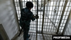 A law enforcement officer closes a gate at a pretrial detention center in Russia. (file photo)