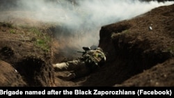 A soldier lies in a trench near Vuhledar, in Ukraine's Donetsk region.