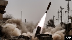 Iraqi troops fire artillery toward Islamic State positions in western Mosul on March 11.